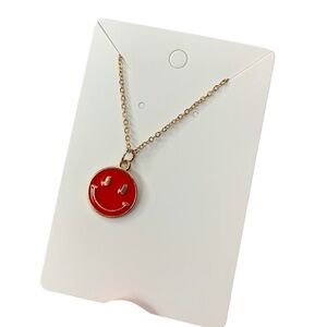 Red and gold smiley face necklace